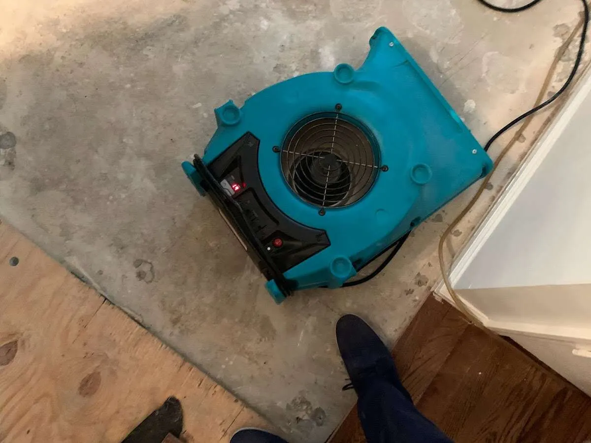 Air mover drying subfloor during Commercial Water Damage Restoration in Twentynine Palms
